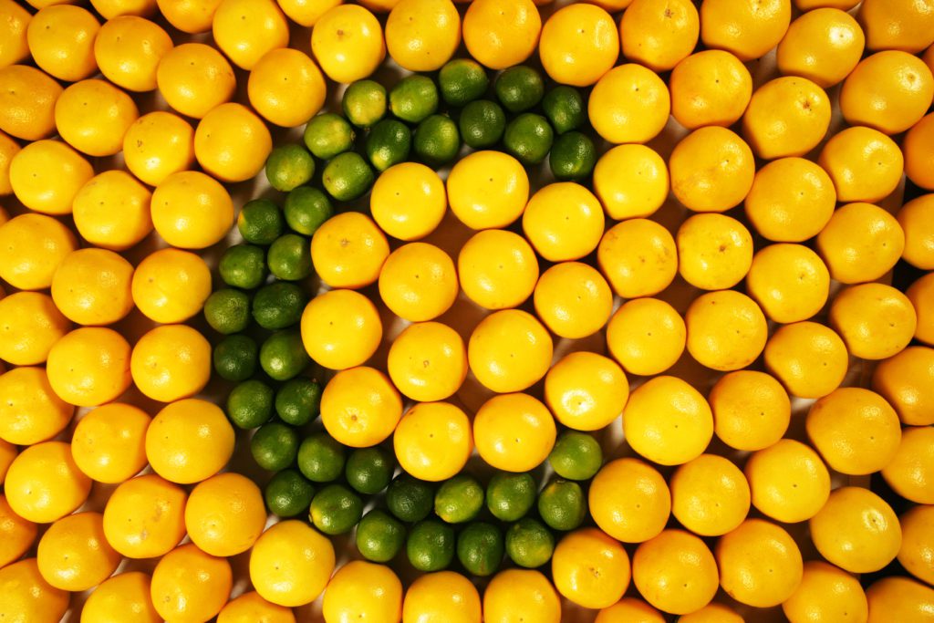 The letter "C" made of limes surrounded by oranges